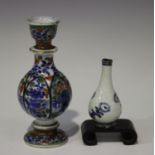 A Chinese 'clobbered' blue and white porcelain diminutive vase, Kangxi period and later, the lobed