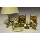 A group of Goebel Hummel figures, including a pair of bookends, a Good Friends lampbase and an