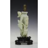 A Chinese pale celadon jade lotus and vase ornament, early 20th century, carved in high relief