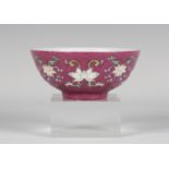 A Chinese famille rose ruby sgraffito ground porcelain bowl, mark of Qianlong and possibly of the