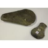 A large pecked stone axe head of expanding form, length 26cm, together with another similar