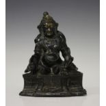 A Sino-Tibetan brown patinated bronze figure of Jambhala, probably early 20th century, the god of