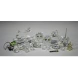 A group of Swarovski Crystal animals, including a dragonfly, two owls, a mouse, two swans and a fox,