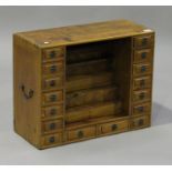 A 20th century Chinese softwood table top cabinet, fitted with sixteen drawers, height 51cm, width