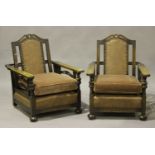 A pair of George V oak reclining library armchairs, the seats and backs covered in brown