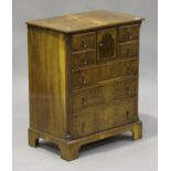 A 20th century reproduction yew bachelor's chest of drawers, fitted with four short drawers and a