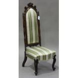 A late Victorian rosewood occasional chair with carved scroll frame, the seat and back upholstered