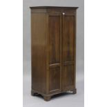 A 20th century Victorian style figured mahogany gentleman's two-door wardrobe, retailed by