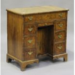 A 19th century George I style walnut kneehole desk with crossbanded decoration, fitted with an