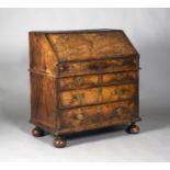 A good Queen Anne walnut bureau with overall feather banding and double-reeded moudings, the fall