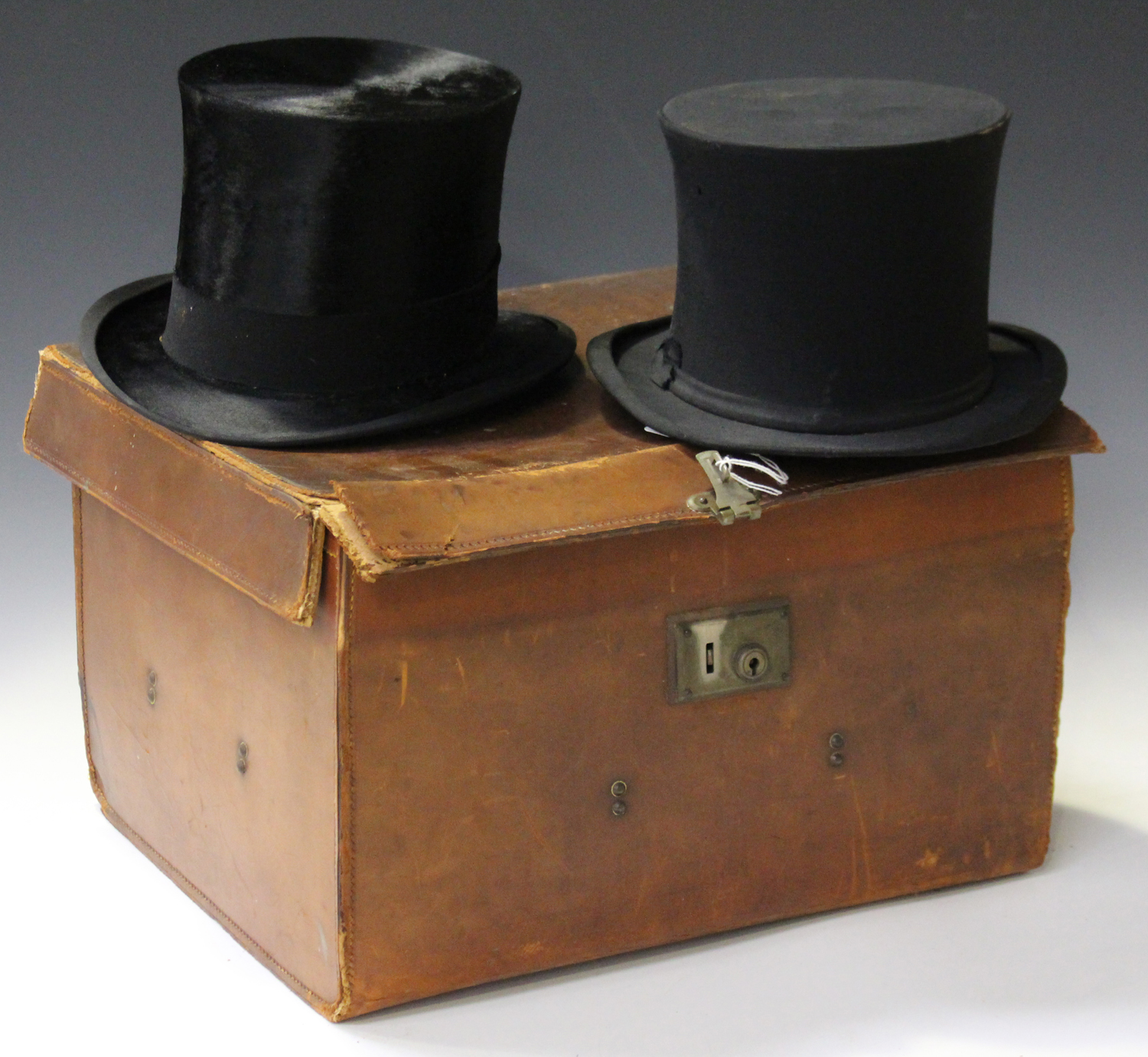 A black moleskin top hat by Lincoln Bennett & Co, London, head circumference 56cm, together with a