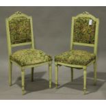 A pair of early 20th century French cream painted salon chairs, the upholstered seats and backs