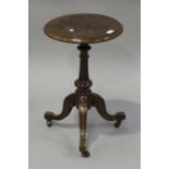 A late Victorian walnut circular occasional table, the fluted column raised on carved scroll legs