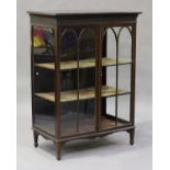 An Edwardian mahogany display cabinet, the moulded pediment above a pair of astragal glazed doors,