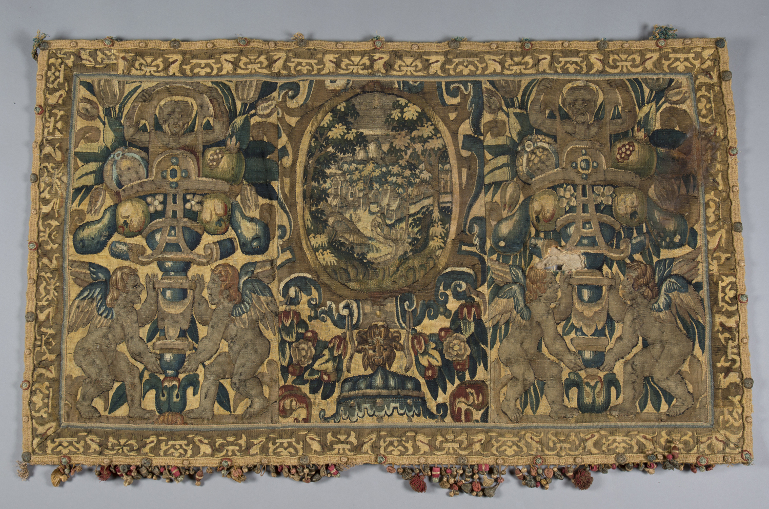 A Flemish tapestry border fragment, mid/late 16th century, probably Brussels, the central oval