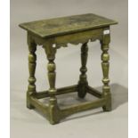 A late 17th century oak joint stool, the rectangular top above a shaped frieze, raised on turned and