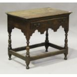 An early 18th century oak lowboy, the moulded top above a single frieze drawer and a shaped