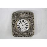 A late Victorian silver mounted travelling watch case, pierced and embossed with 'C' scrolls and