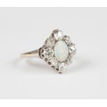 An opal and diamond lozenge shaped cluster ring, mounted with an oval opal within a surround of