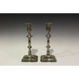 A pair of George V silver baluster candlesticks, each cylindrical sconce with detachable nozzle,