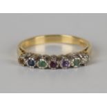A gold and gemstone set ring, the gemstones mounted to spell 'Dearest', detailed '18ct', ring size