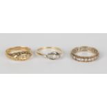 An 18ct gold and diamond five stone ring, Birmingham 1915, a gold and diamond three stone ring,