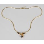 An 18ct gold, sapphire and diamond necklace, the front with stylized foliate motifs, mounted with