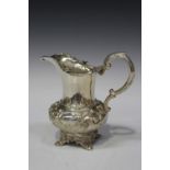 An early Victorian silver milk jug, the low-bellied body chased with scrolling foliage, London