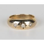 A 9ct gold and diamond three stone ring, star gypsy set with circular cut diamonds, ring size approx