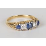 A gold, sapphire and diamond five stone ring, mounted with three cushion cut sapphires alternating