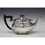 A George V silver teapot of cushion form with bead and reel rim, on paw feet, Sheffield 1928 by