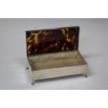 A George V silver and tortoiseshell rectangular dressing table box, raised on claw and ball feet,