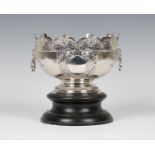 A late Victorian Queen Anne style Britannia silver monteith, the half-fluted circular bowl with