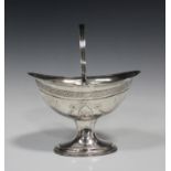 A George III Irish silver oval sugar basket with swing handle, bright-cut engraved with festoons