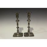 A pair of George V silver baluster candlesticks, each cylindrical sconce with detachable nozzle,