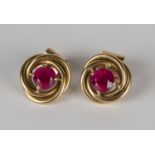 A pair of gold and synthetic ruby single stone earrings, each claw set with a circular cut synthetic