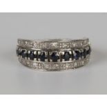 A white gold, ruby, sapphire and diamond swing-over eternity ring, the principal band mounted with