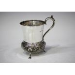 An Edwardian silver christening mug of low-bellied form, embossed and engraved with flowers and