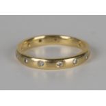 An 18ct gold and diamond eternity ring, mounted with circular cut diamonds, ring size approx M, with