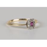 A gold, ruby and diamond rectangular cluster ring, mounted with an oval cut ruby within a surround