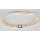 A two row necklace of uniform cultured pearls on a 9ct gold and mabé pearl clasp, length of shortest