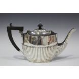 An Edwardian silver teapot of half-reeded oval form, Birmingham 1903 by William Devenport, height