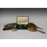 A George V silver four-piece dressing table set with foliate reeded borders, comprising hairbrush,