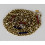 A gold, seed pearl and enamelled long chain, spaced with red and blue enamelled baton shaped links