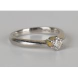 A platinum and diamond single stone ring, claw set with a circular cut diamond, detailed '033', ring