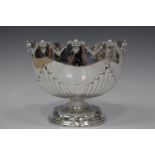 A late Victorian silver monteith of half-reeded form beneath a scallop and scroll rim, London 1896