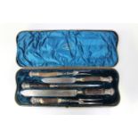 A late 19th century plate mounted stag antler handled five-piece carving set, comprising two knives,