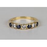 An 18ct gold, sapphire and diamond set seven stone half-hoop ring, mounted with four circular cut