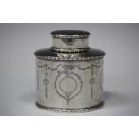 A George V silver oval tea caddy, engraved with opposing bellflower pendant cartouche and bellflower