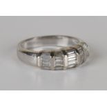 A white gold and diamond ring, mounted with five rows of four graduated baguette cut diamonds,